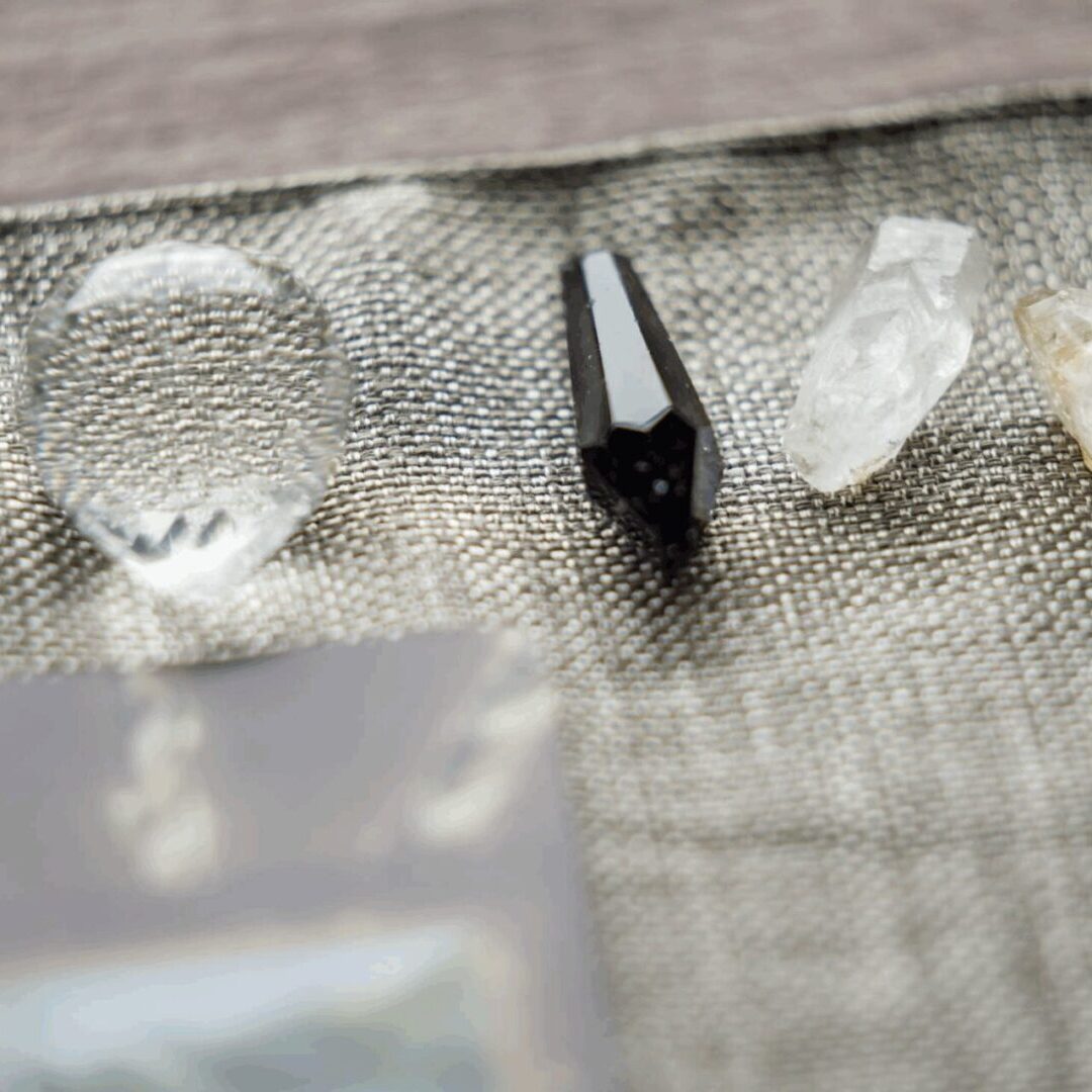 Four distinct crystals on a fabric surface in soft light.